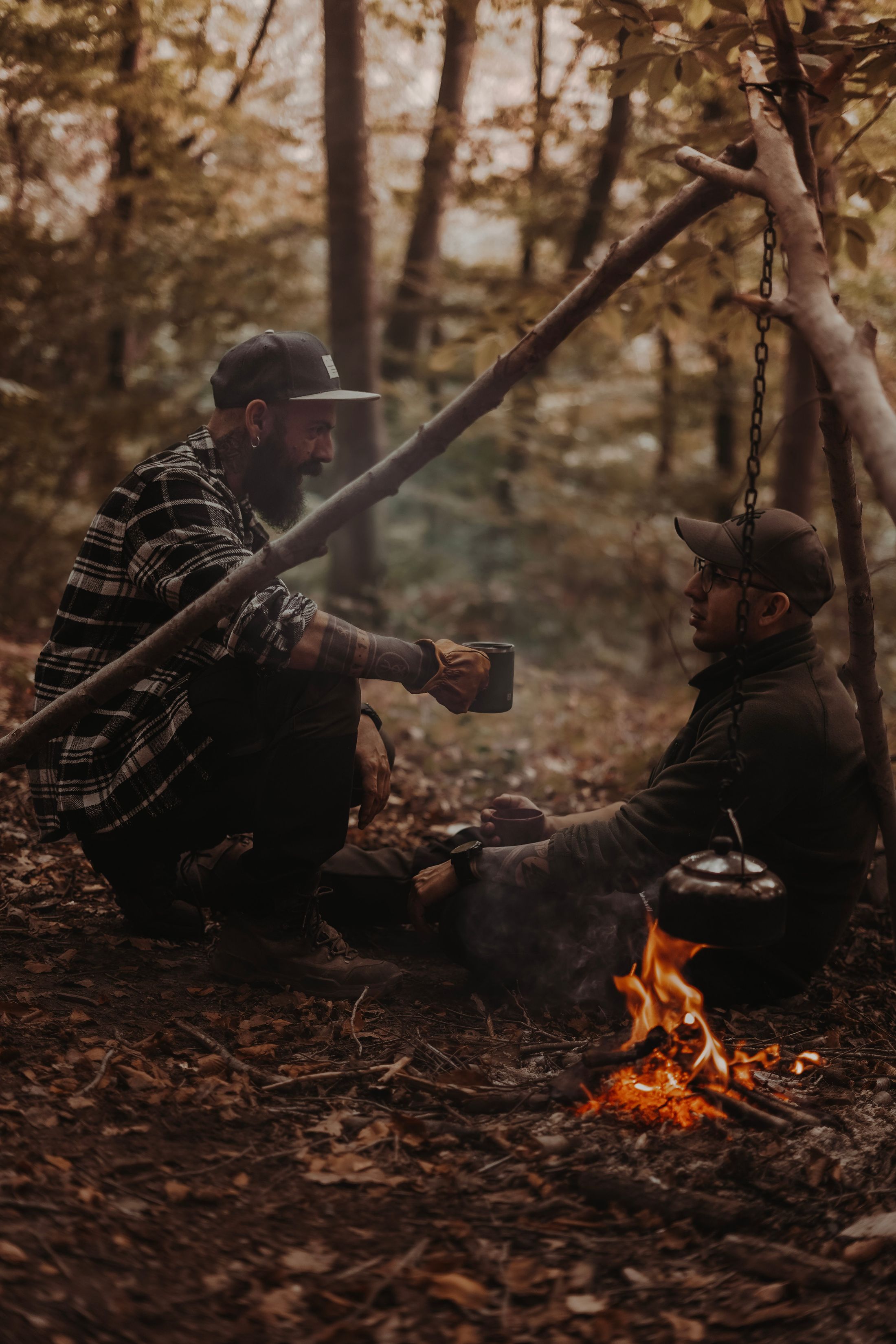 People gathered quietly around a campfire in the dark