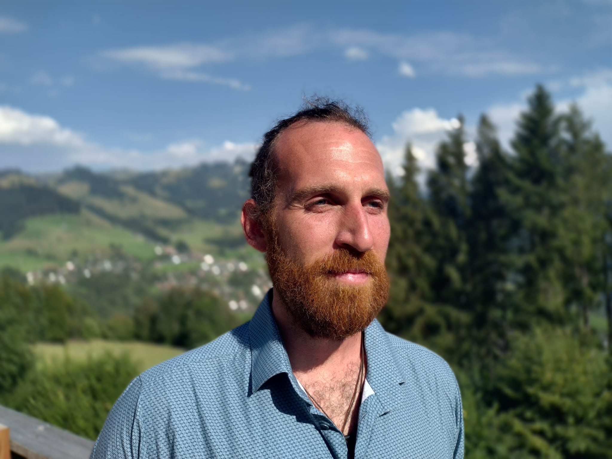 Portrait of Ruben Carpentier with the Swiss Alps behind him