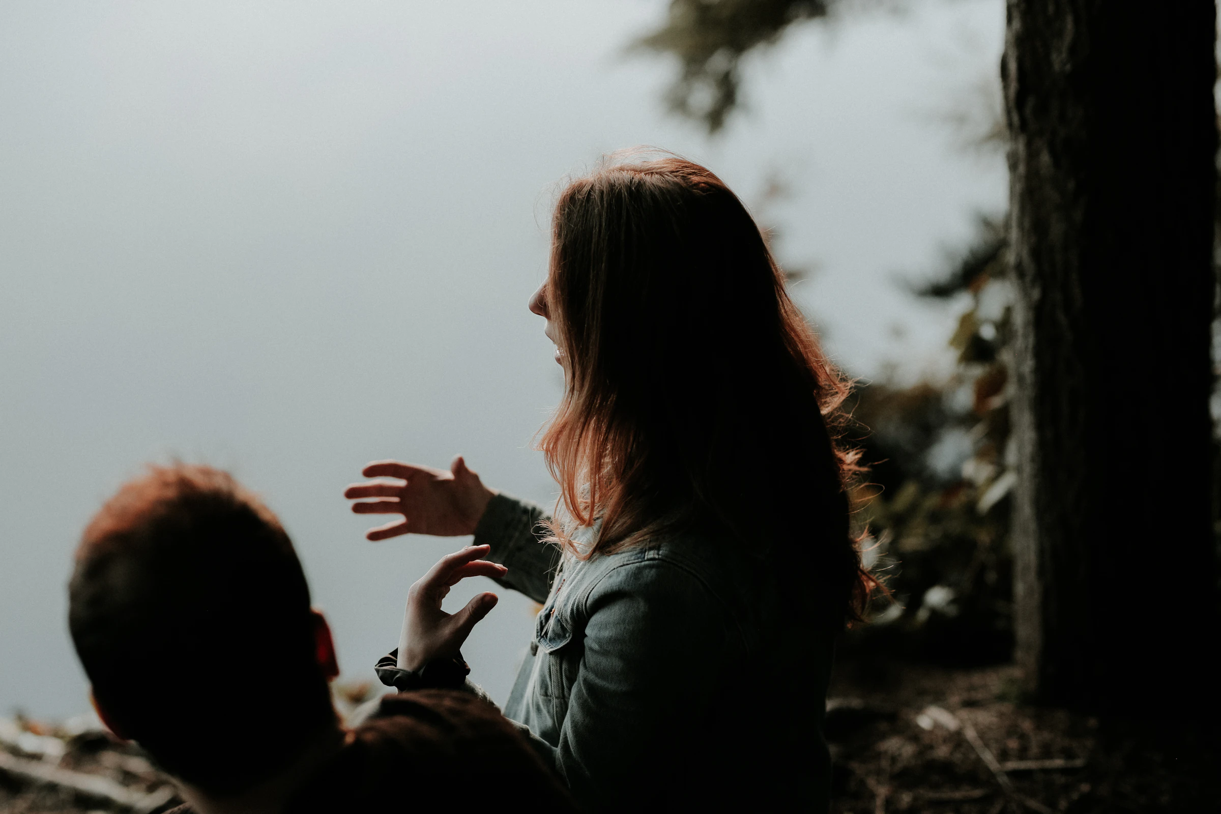 Two leaders in a candid conversation beside a lake
