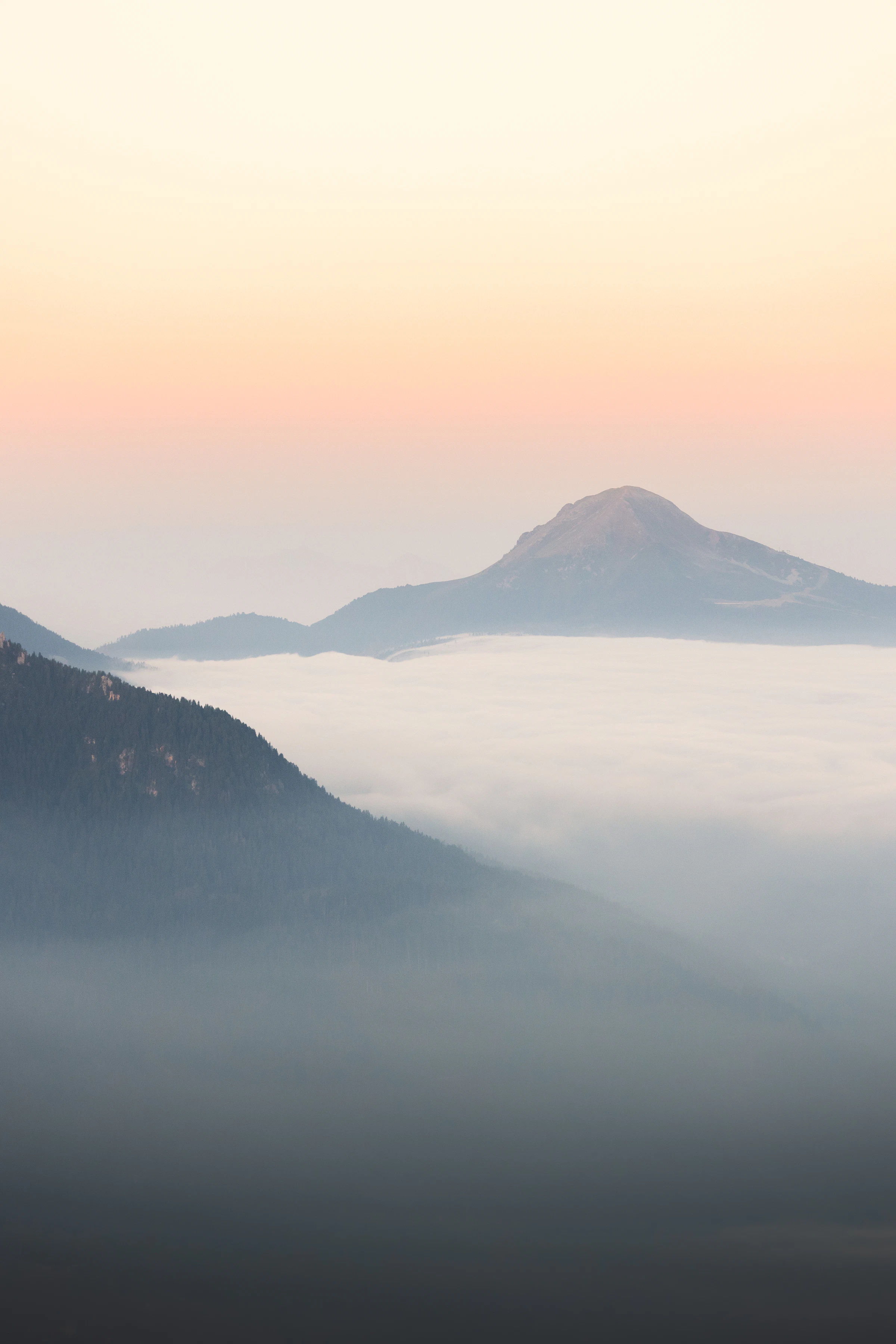 Mountain ridges rising above a field of morning mist